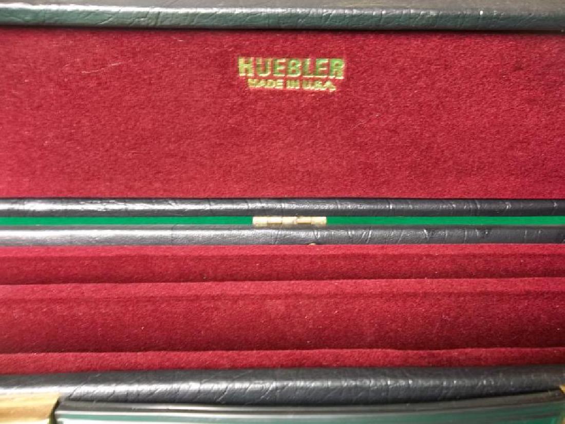 Huebler Pool Cue, 2 piece, 58", scratches on butt: Huebler Pool Cue, 2 piece, 58", scratches on butt sleeve and forearm, ring on shaft is scratched, stained butt end and ferrule, hard black Huebler case with handle, 32",sleeve and forearm, ring on sha