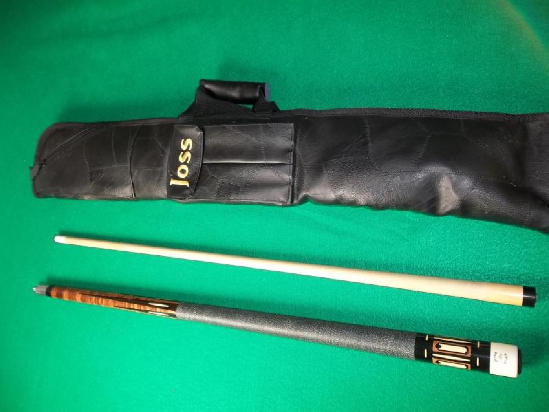 Joss Pool Cue, 2 piece, dent and scratches on: Joss Pool Cue, 2 piece, dent and scratches on butt sleeve, forearm, 57 3/4", soft black vinyl Joss case with pocket and handle, zippered compartment, 34" l,butt sleeve, forearm, 57 3/4", soft black vi