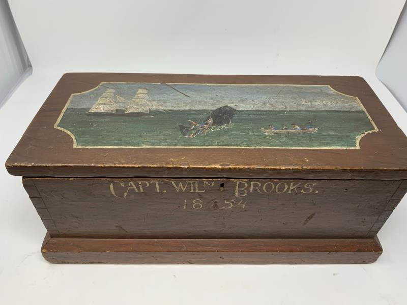 Sailor: "Captain William Brooks 1854" with grain painted brown with painted whale scene on front lid, dovetailed, no rope handles, repair to rear hinge area, scrapes and gouges on front lid, some paint loss, 