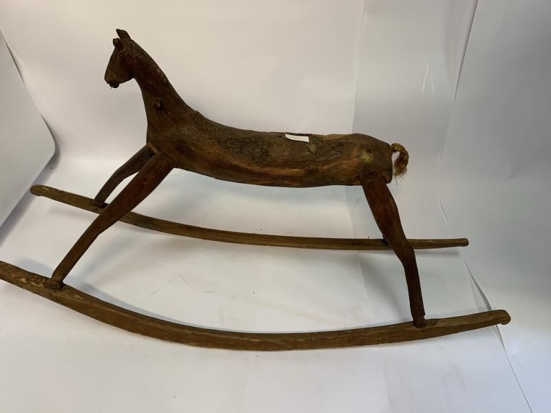 Child: wooden, hand-carved, primitive style, wooden ears, rope tail, bark still on seat, 26" t x 48" l x 14" w
