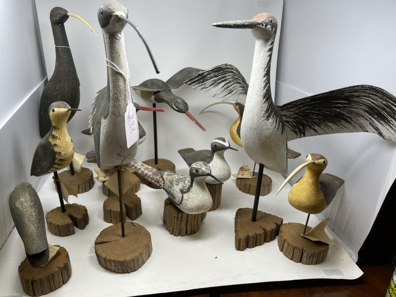 12 Contemporary Decoys all on wooden stands and 11 with: all on wooden stands and 11 with paper tags, contemporary carvings, 7" tall to 19" tall