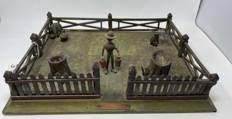 Folk Art Farm Yard Display Wooden fence with man on: Wooden fence with man on stump, painted green with decorative stump missing to front top rail, other rails repaired, 4" tall x 13" x 17"