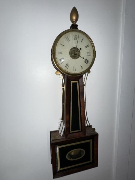 Banjo Clock, mahogany veneer, stenciled gold lower: Banjo Clock, mahogany veneer, stenciled gold lower door, acorn finial- small chips, brass pcs, wt. & pendulum, no key, painted metal dial worn