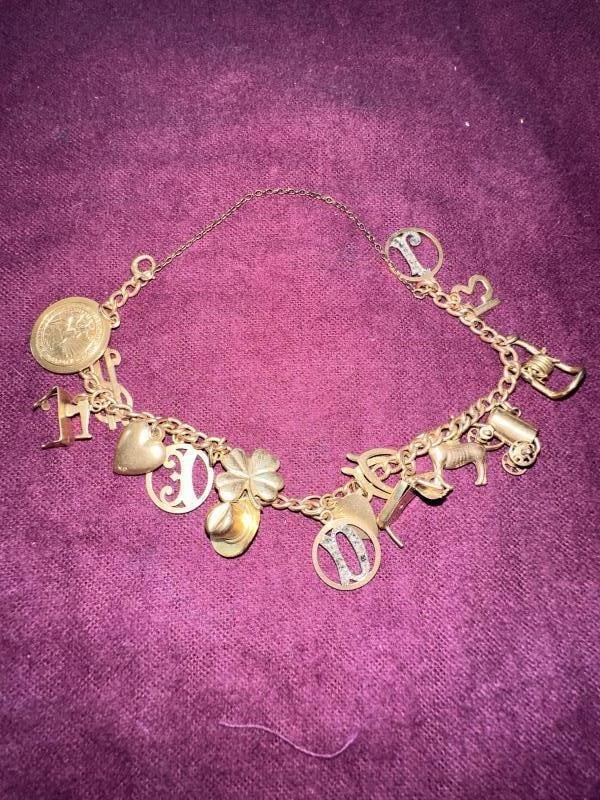 Charm Bracelet, 16 charms, most 10K gold (18 grams: Charm Bracelet, 16 charms, most 10K gold (18 grams)Unless You Are A Liveauctioneers Premium Bidder This Lot Must Be Paid For By Cash, Bank Check or Wire Transfer.