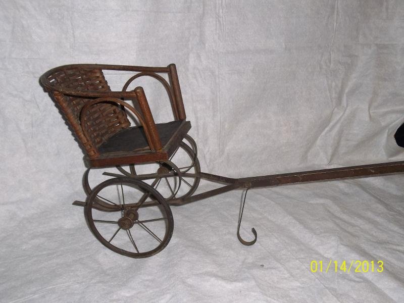Doll's pull wagon, wicker back with leather seat: Doll's pull wagon, wicker back with leather seat chair measures 8" x 10" chair measures 8" x 10" with a 24" wooden handle 50-150