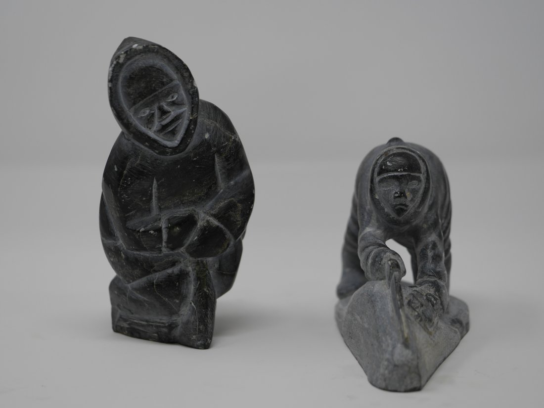 Inuit Carved Soapstone Sculptures: Pair of hand carved Inuit soapstone sculptures with inuit markings. Sculpture of woman reads "ma ma" on the bottom.