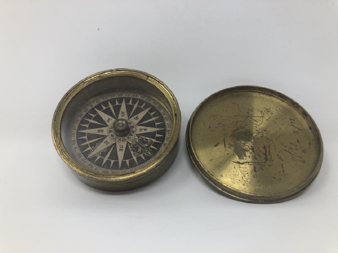 19th Century Richard Patten Pocket Compass: The dial is signed (R. Patten New York) which is Richard Patten (1792-1865). It does work. There are scratches on the brass. Measures 2.25 inches wide.