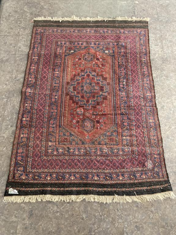 Vintage Area Rug: Exact manufacturer or culture unknown, but consigner spent many years in Egypt and the Middle East. Shows some holes and some pulls. Measures 86" x 59".