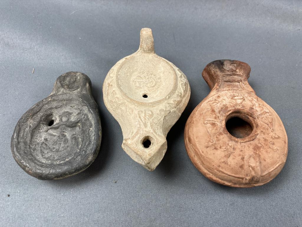 Three Antique Oil Lamps: Cannot be certain of the specific cultures or makers, but consigner lived for many years in Egypt and the Middle East. Largest lamp (the center one in the pictures) measures 4.25" long.
