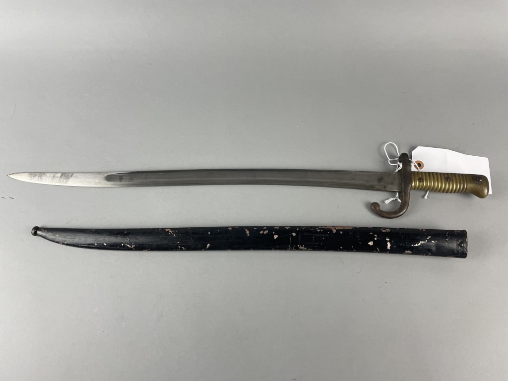French M1866 Chassepot Bayonet: Manufactured 1869, 22.5in blade, unit marked 82.L.I.4.133. & black painted scabbard.