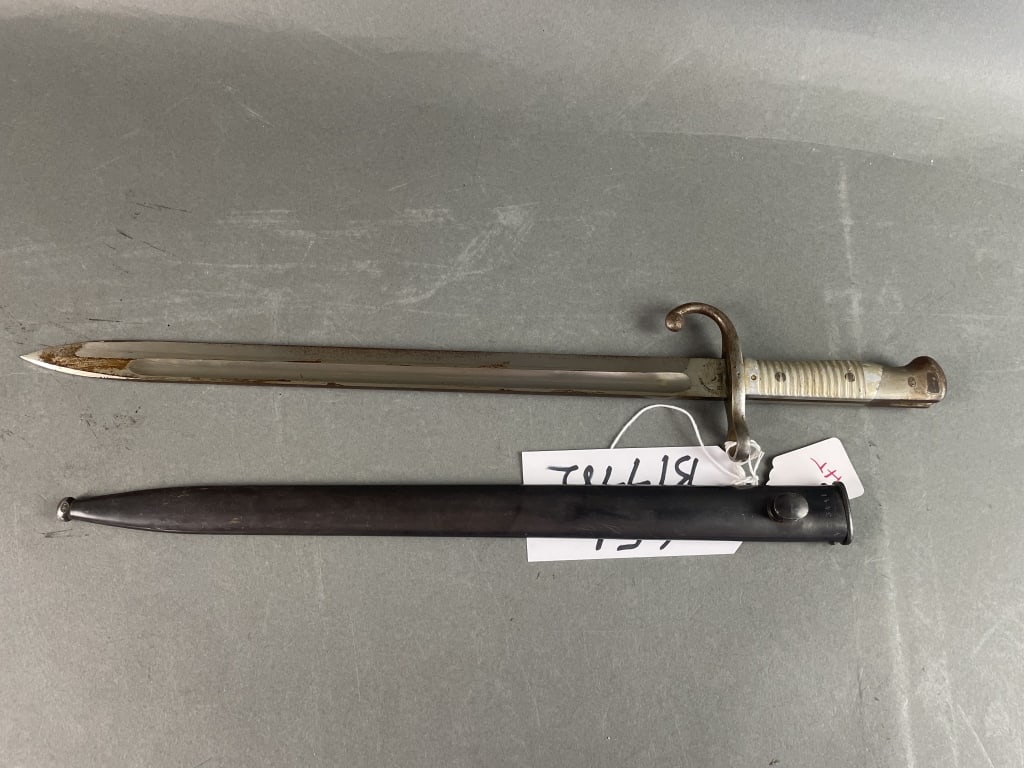 Model 1891 Argentine Bayonet WKC: Bright blade/Blued scabbard 80% finish- rust spotting to blade. Very good condition. Serial numbers March. Alloy handle. Ground crest. Serial number- H3441