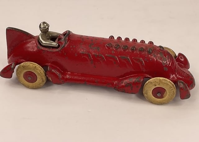 ANTIQUE RED TOY CAST IRON RUBBER WHEELS CAR RACE CAR: ANTIQUE RED TOY CAST IRON RUBBER WHEELS RACE CAR. Not sure who made this but it is very old (antique) and in my opinion just looks really cool. Does have some paint loss and wheels have wear but are a