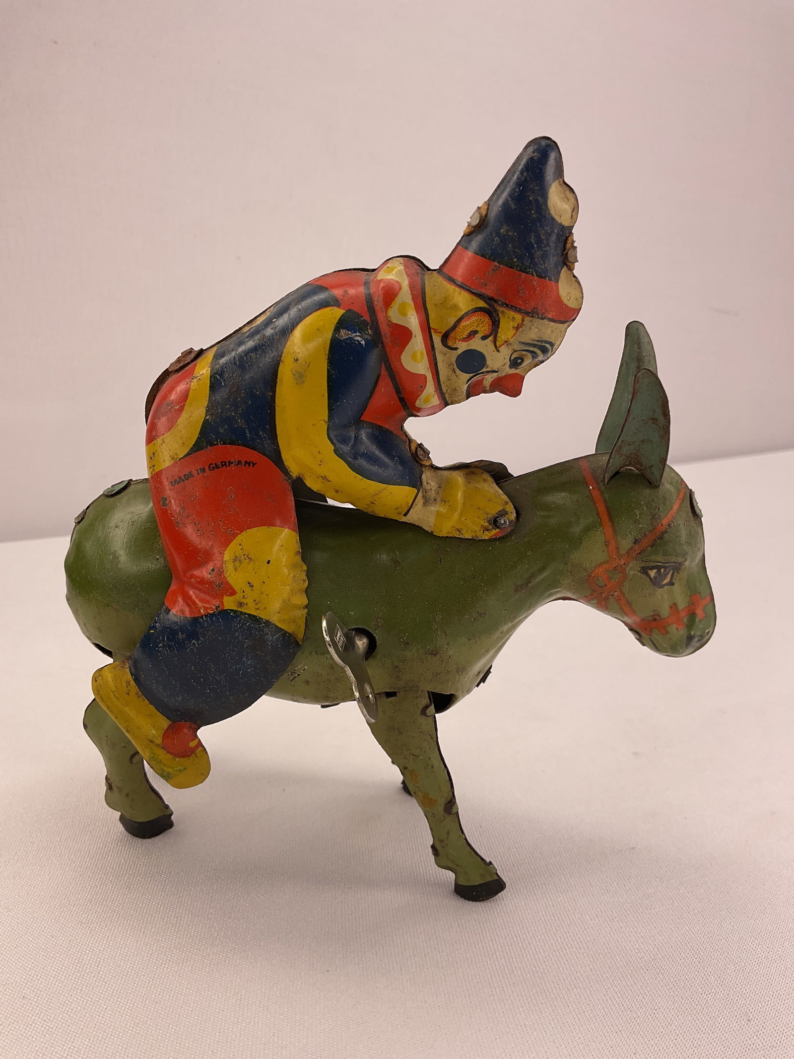 Bucking Donkey Tin Toy Clown Made in Germany: Bucking Donkey Tin Toy Clown Made in Germany. As with all wind-up toys if you are interested in seeing the toy work I can text you a video of the toy working so you can see it in video and not just tr
