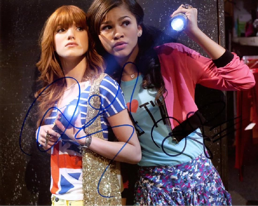 Zendaya / Bella Thorne 8x10 Photo from the TV series: Zendaya / Bella Thorne in person signed autographed photo from the Disney series SHAKE IT UP. Zendaya as the character Rocky Blue. Bella Thorne as the character CeCe Jones. Comes with COA