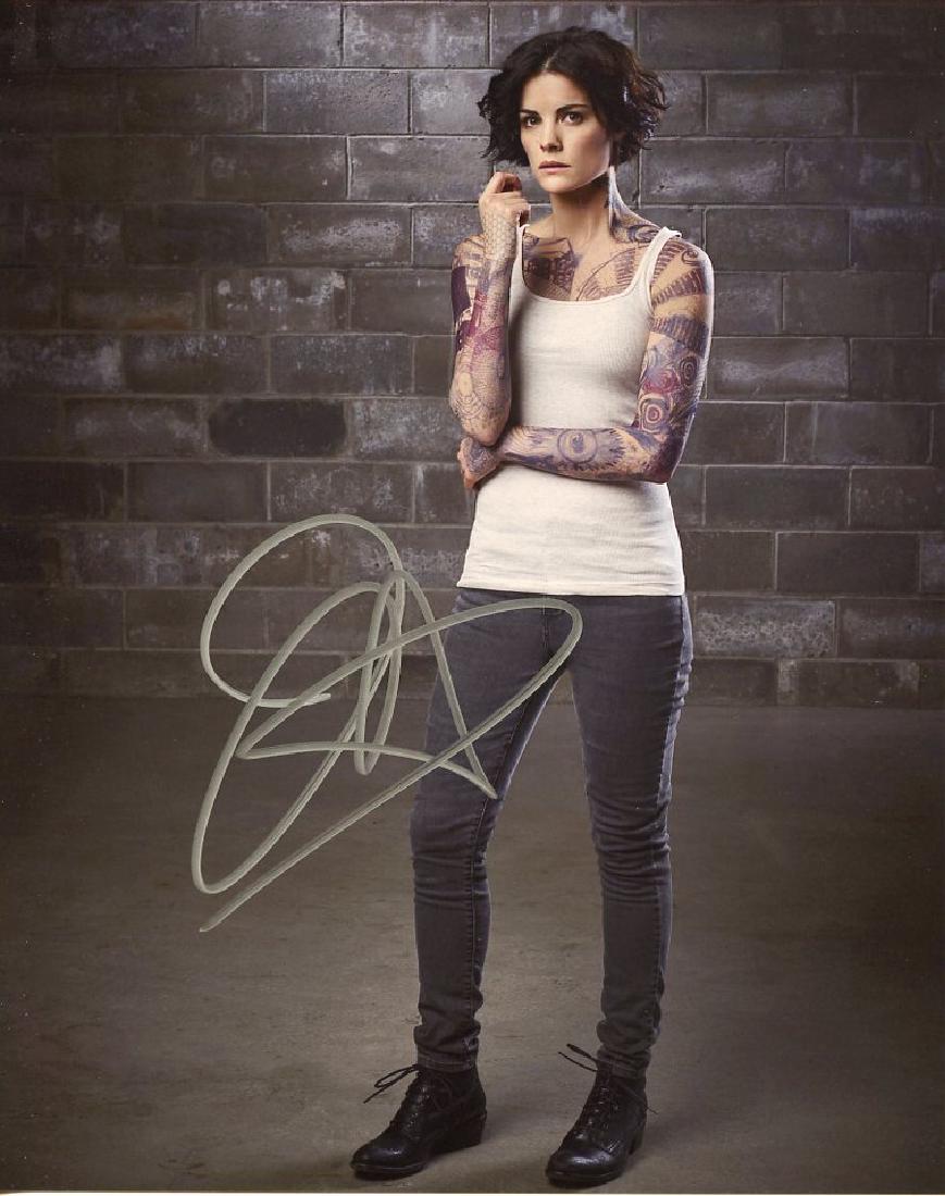 Jaimie Alexander BLINDSPOT In Person Signed Photo: Jaimie Alexander in person signed autographed photo from the TV series BLINDSPOT. Jaimie Alexander as the character Jane Doe. Comes with COA. Photo size is 8 x 10. Date & signing location provided