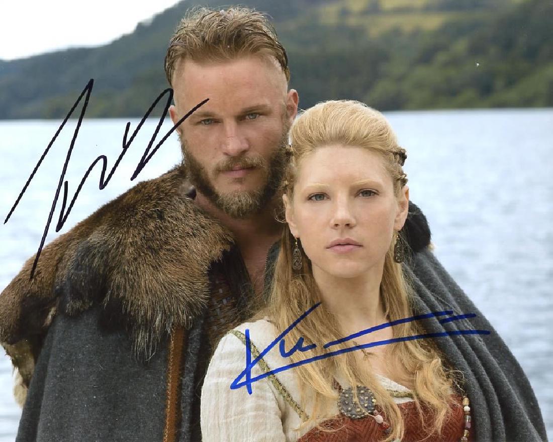 Travis Fimell / Katheryn Winnick VIKINGS In Person: Travis Fimmel / Katheryn Winnick in person signed autographed photo from the HBO series VIKINGS. Travis Fimmel as the character Ragnar Lothbrok. Katheryn Winnick as the character Lagertha. Photo sizes