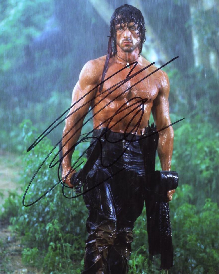 Sylvester Stallone RAMBO In Person Signed Photo #1: Sylvester Stallone in person signed photo from the movie RAMBO. Sylvester Stallone as the character RAMBO. Photo size is 8x10.