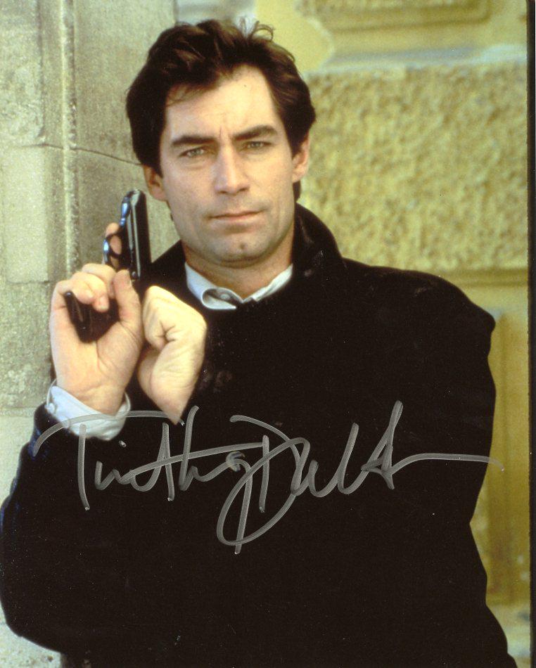 Timothy Dalton JAMES BOND 007 In Person Signed Photo: Timothy Dalton in person signed autographed photo as the character James Bond. Timothy Dalton played James Bond into movies THE LIVING DAYLIGHTS and LICENSE TO KILL. Photo size is 8 x 10