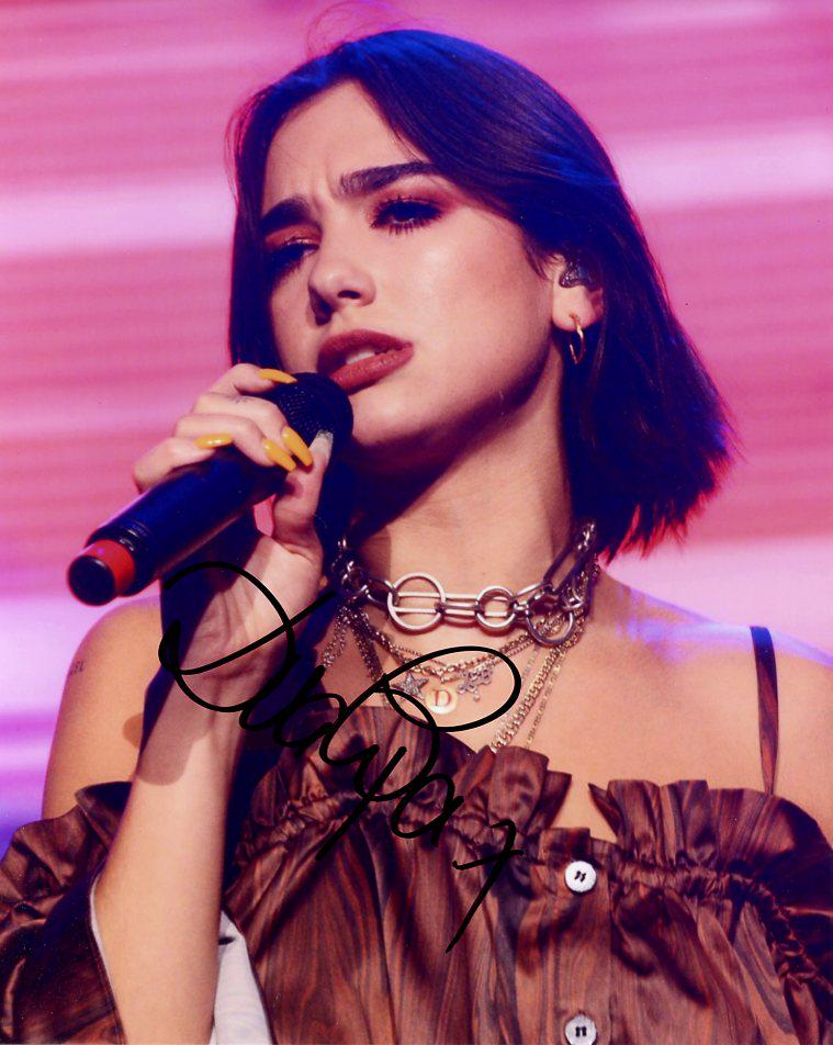 Dua Lipa MUSICIAN In Person Signed Photo: Dua Lipa is an English singer and songwriter. After working as a model, she signed with Warner Music Group in 2015 and released her eponymous debut album in 2017.