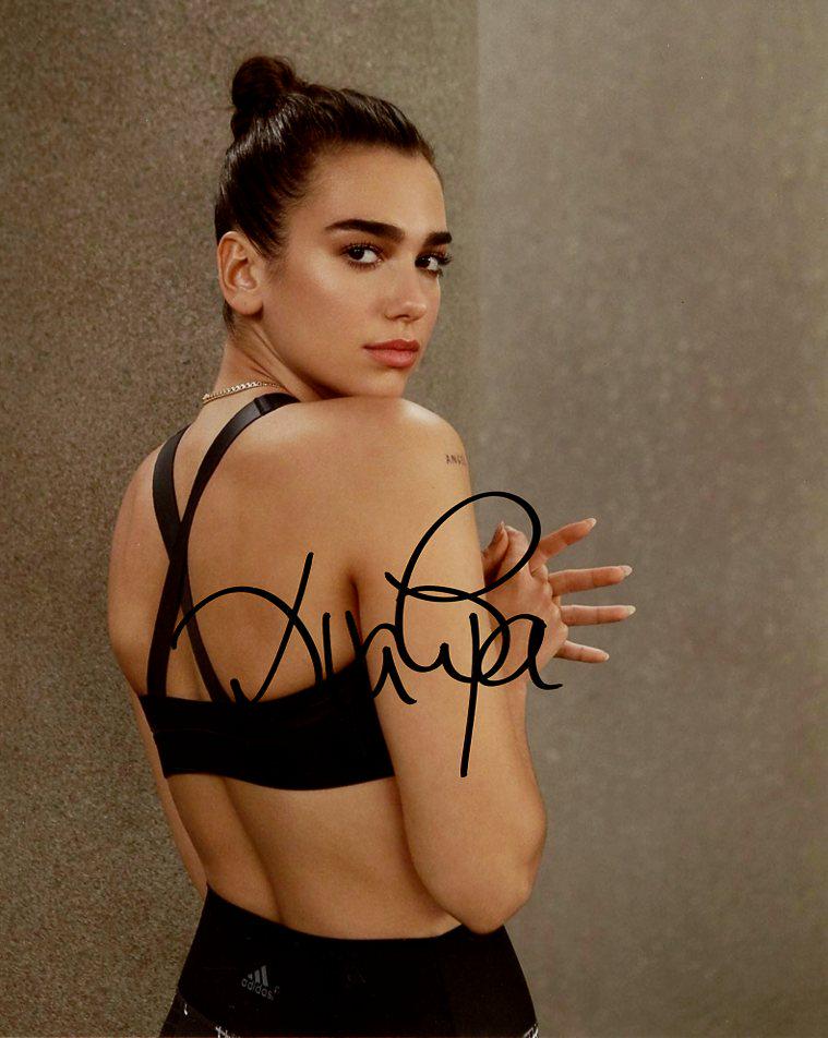 Dua Lipa MUSICIAN In Person Signed Photo: Dua Lipa is an English singer and songwriter. After working as a model, she signed with Warner Music Group in 2015 and released her eponymous debut album in 2017.