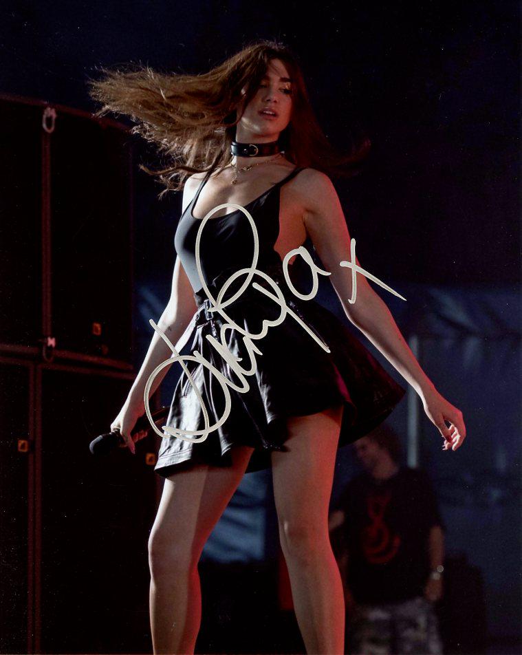 Dua Lipa MUSICIAN In Person Signed Photo: Dua Lipa is an English singer and songwriter. After working as a model, she signed with Warner Music Group in 2015 and released her eponymous debut album in 2017.