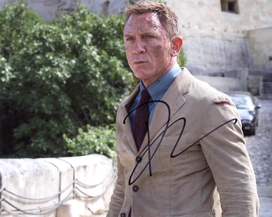 Daniel Craig NO TIME TO DIE Signed Photo: Daniel Craig in person signed autographed photo from the movie NO TIME TO DIE. Daniel Craig as the character James Bond 007.