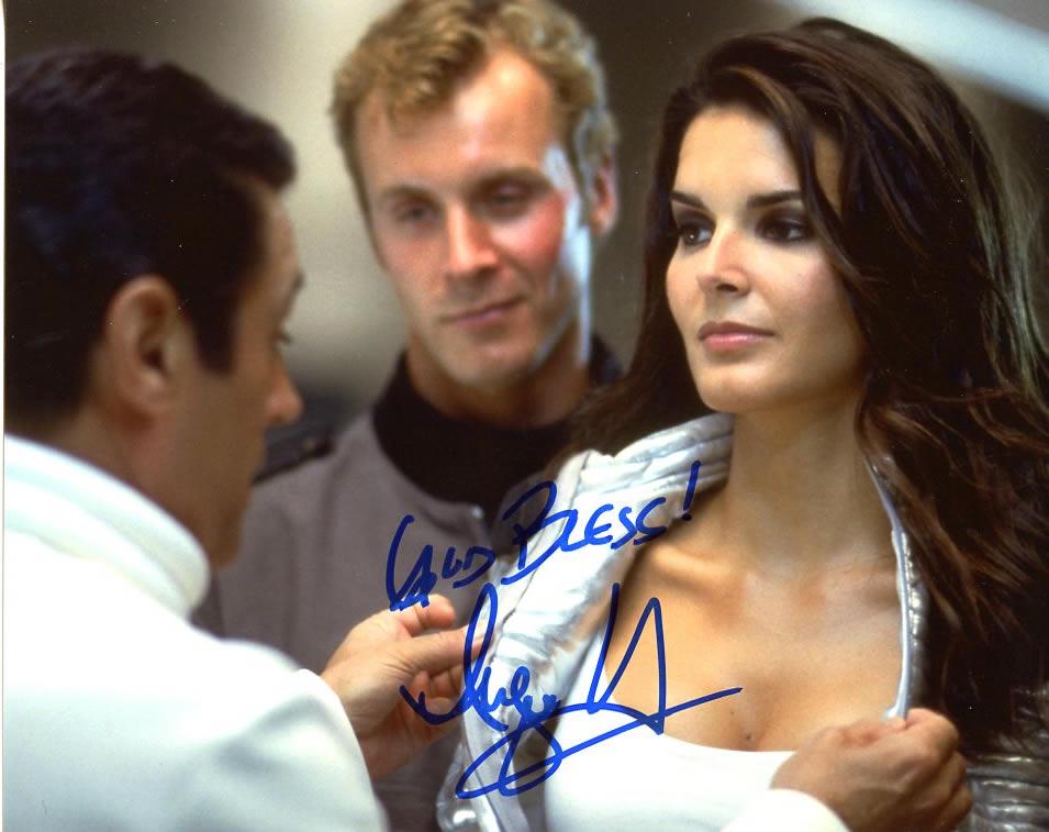 Angie Harmon AGENT CODY BANKS Signed Photo: Angie Harmon in person signed autographed photo from the movie AGENT CODY BANKS. Angie Harmon as the character Ronica Miles