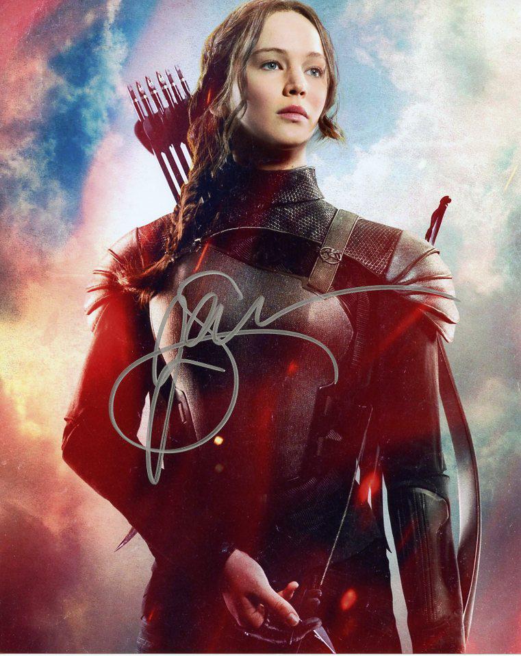 Jennifer Lawrence HG MOCKINGJAY PT 2 Signed Photo: Jennifer Lawrence in person signed autographed photo from the movie THE HUNGER GAMES MOCKING JAY PT 2. Jennifer Lawrence as the character Katniss Everdeen