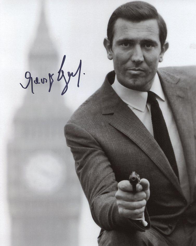 George Lazenby JAMES BOND Signed Photo: George Lazenby in person signed autographed photo from the movie ON HER MAJESTY'S SECRET SERVICE. George Lazenby as the character James Bond / 007