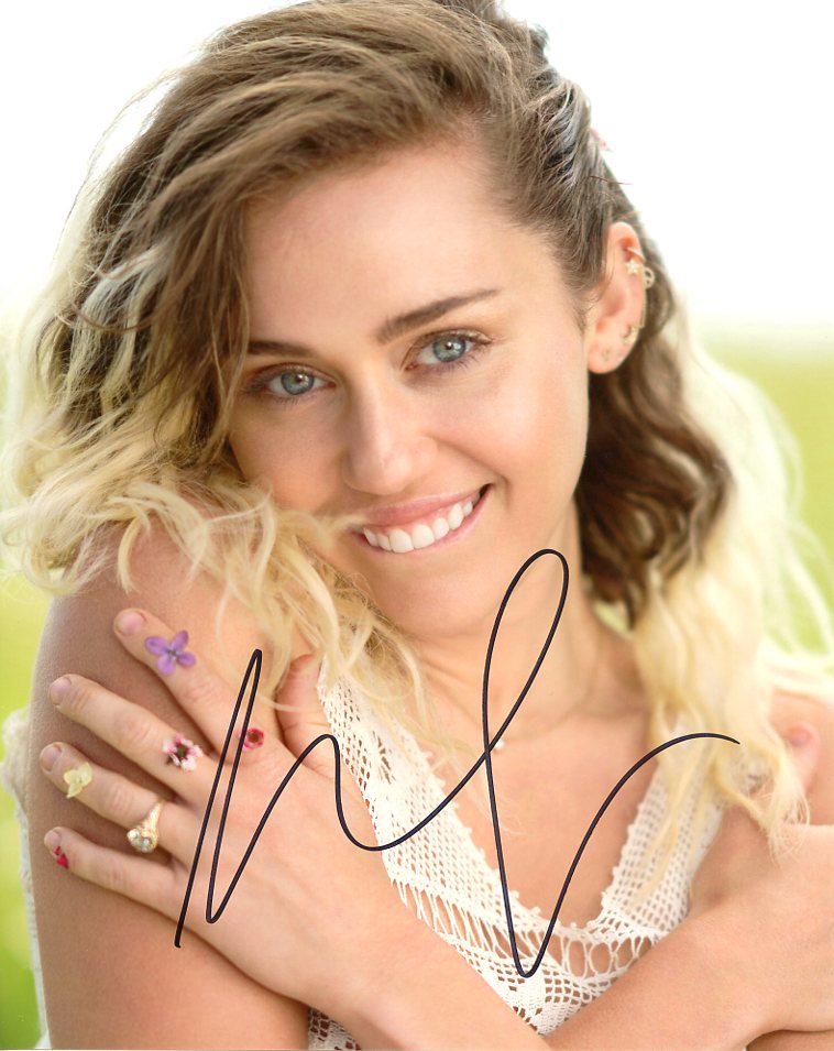 Miley Cyrus SEXY PLAYFUL Signed Photo: Miley Cyrus hot in person signed photo. Miley Cyrus has been in such movies as THE LAST SONG, LOL, and HANNAH MONTANA