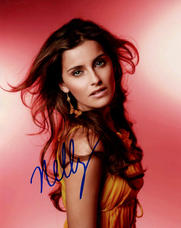 Nelly Furtado MUSICIAN In Person Signed Photo: Nelly Furtado is a Canadian singer and songwriter. She first gained fame with her trip hop-inspired debut album, Whoa, Nelly!, which was a critical and commercial success that spawned two top-10 singl