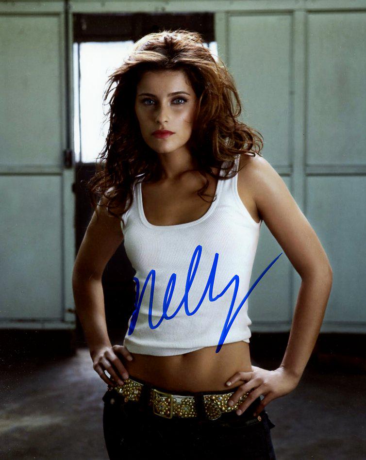 Nelly Furtado MUSICIAN In Person Signed Photo: Nelly Furtado is a Canadian singer and songwriter. She first gained fame with her trip hop-inspired debut album, Whoa, Nelly!, which was a critical and commercial success that spawned two top-10 singl