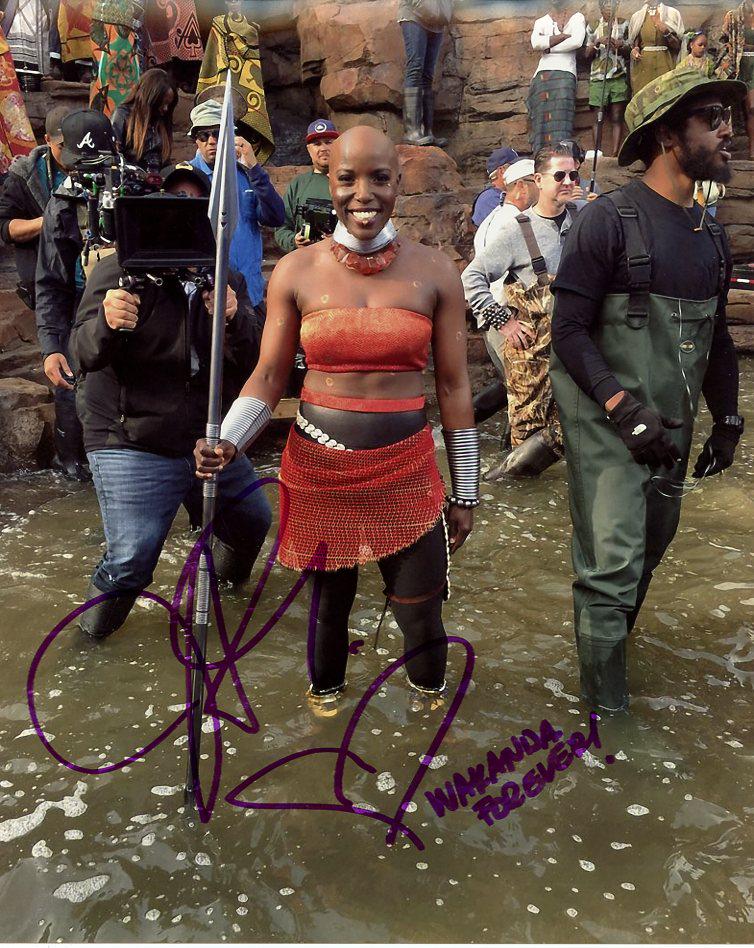 Janeshia Adams-Ginyard BLACK PANTHER In Person Signed: Janeshia Adams-Ginyard in person signed autographed photo from the movie BLACK PANTHER. Janeshia Adams-Ginyard is a stuntwoman, actress, professional wrestler and sports radio personality.