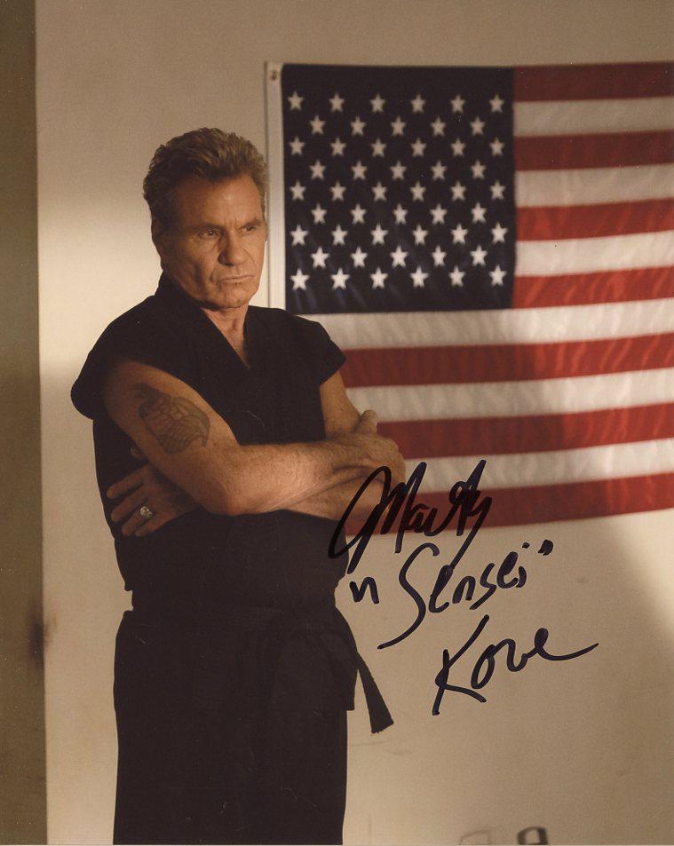Martin Kove COBRA KAI In Person Signed Photo: Photo size is 8x10. Martin Kove in person signed autographed photo from the TV series COBRA KAI. Martin Kove as the character John Kreese