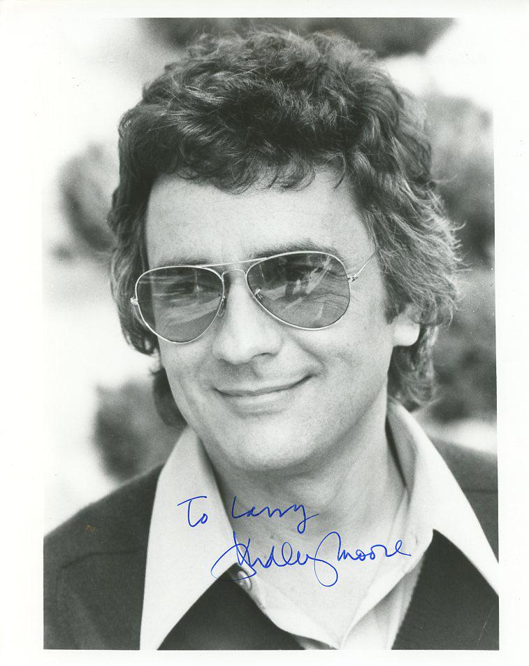 Dudley Moore (1935-2002) HEADSHOT Signed Photo: Photo size is 8x10. Dudley Moore (1935-2002) Handsome headshot signed photo. One of Dudley Moore's most memorable movies is ARTHUR. PLEASE NOTE: This is inscribed to Larry