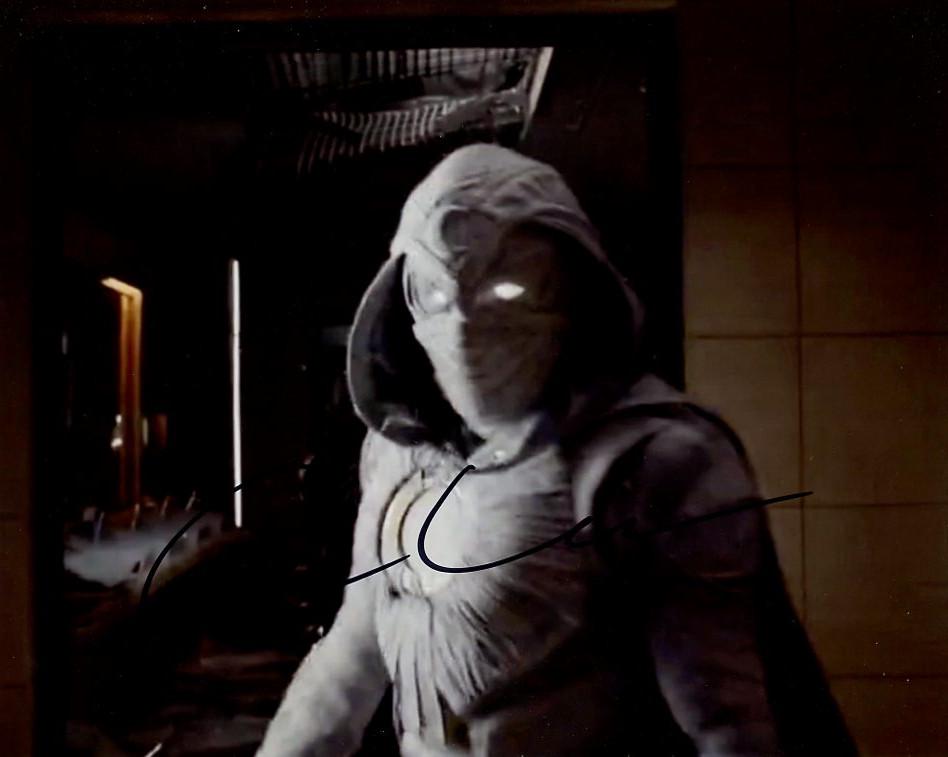 Oscar Isaac MOON KNIGHT In Person Signed Photo: Photo size is 8x10. Oscar Isaac in person signed photo from the TV series MOON KNIGHT. Oscar Isaac as the character Marc Spector. IMPERFECTIONS: slightly blurry image
