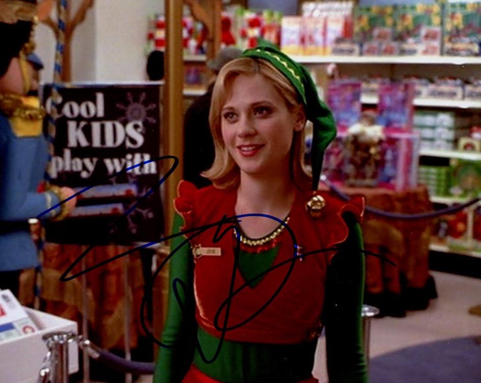 Zooey Deschanel ELF In Person Signed Photo: Photo size is 8x10. Zooey Deschanel in person signed autographed photo from the movie ELF. Zooey Deschanel as the character Jovie. IMPERFECTIONS: slightly grainy image