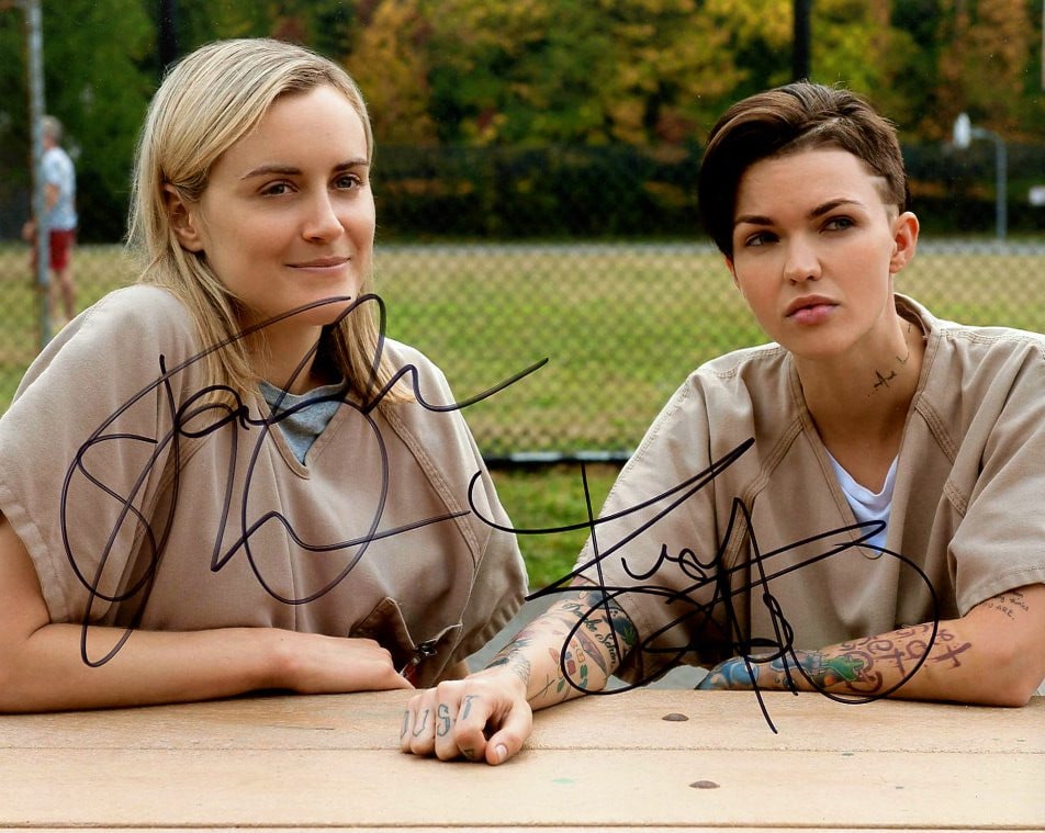 Taylor Schilling / Ruby Rose OITNB In Person Signed Photo: Photo size is 8x10. Taylor Schilling / Ruby Rose in person signed autographed photo from the TV series ORANGE IS THE NEW BLACK. Taylor Schilling as the character Piper Chapman. Ruby Rose aas the chara