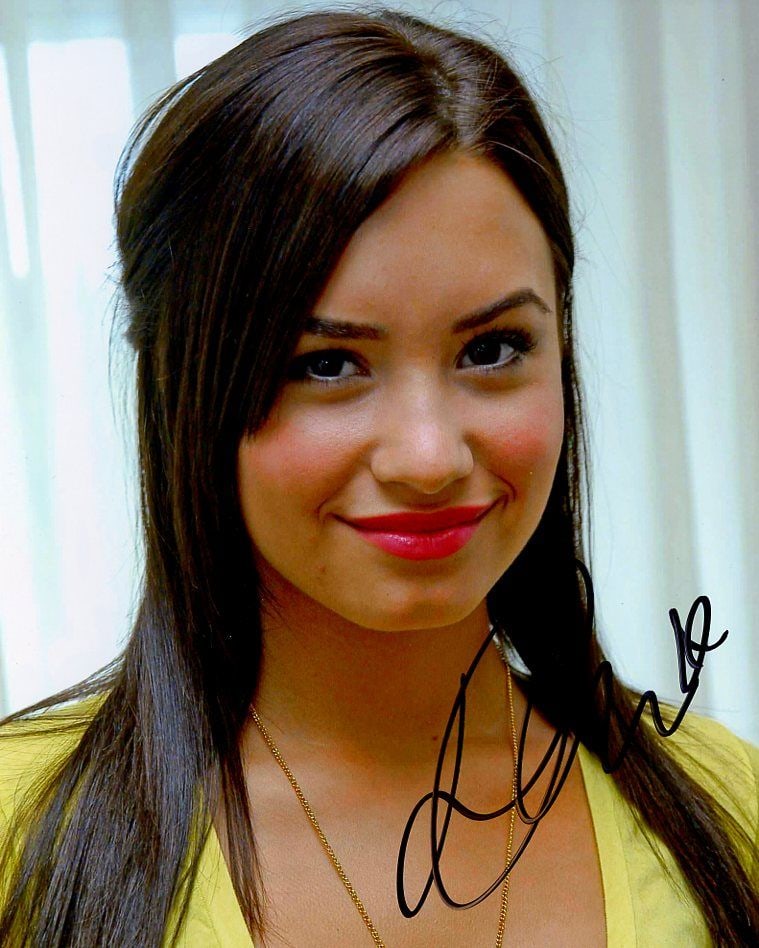 Demi Lovato CAMP ROCK In Person Signed Photo: Photo size is 8x10. Demi Lovato in person signed autographed photo. Demi Lovato is an American singer, songwriter, and actress. After appearing on the children's television series Barney & Friends, Lo