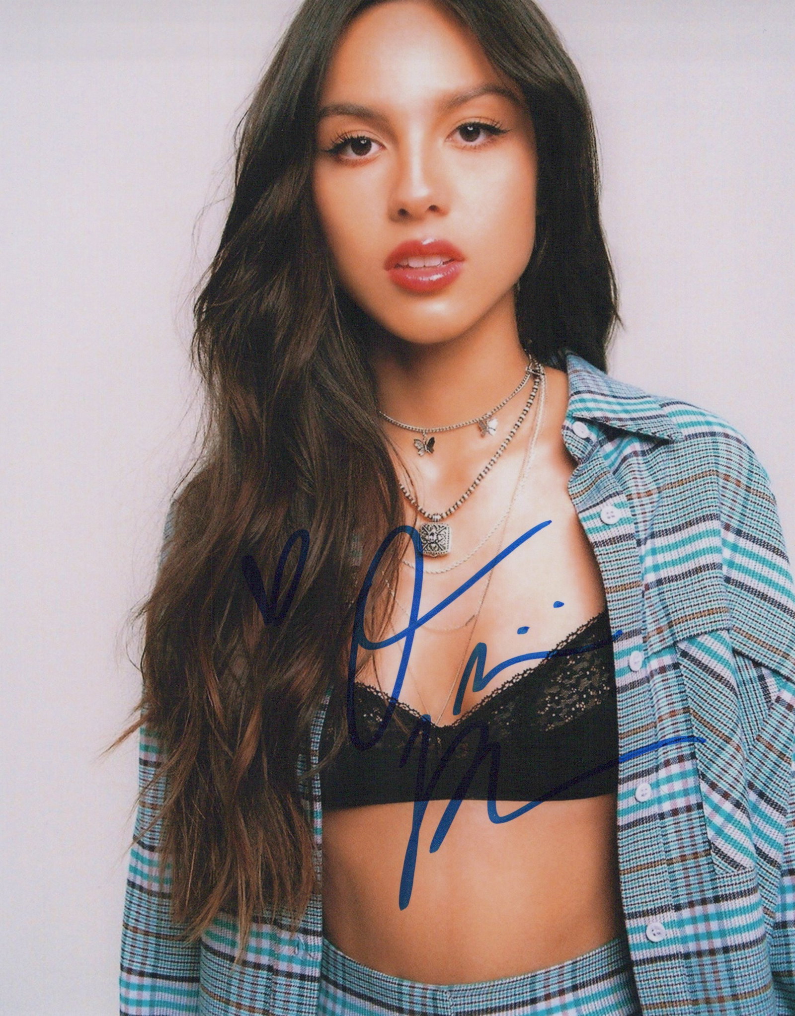 Olivia Roderigo SINGER In Person Signed Photo: Photo size is 8x10. Olivia Roderigo in person signed photo. Olivia Roderigo is an American singer-songwriter and actress. She first rose to prominence for starring on the Disney Channel series Bizaard