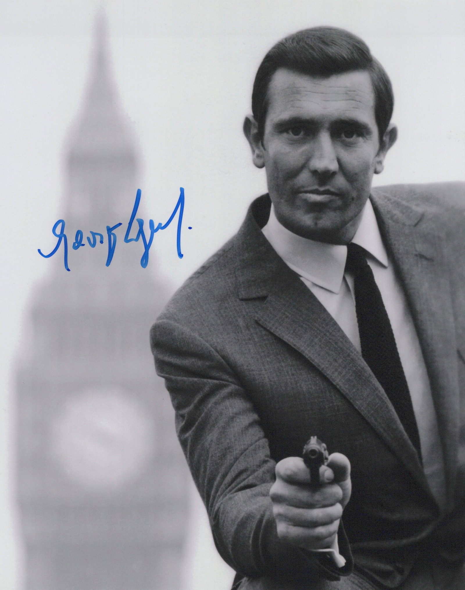 George Lazenby ON HER MAJESTY'S SECRET SERVICE In Person Signed Photo: Photo size is 8x10. George Lazenby in person signed autographed photo from the movie ON HER MAJESTY'S SECRET SERVICE. George Lazenby as the character James Bond / 007.