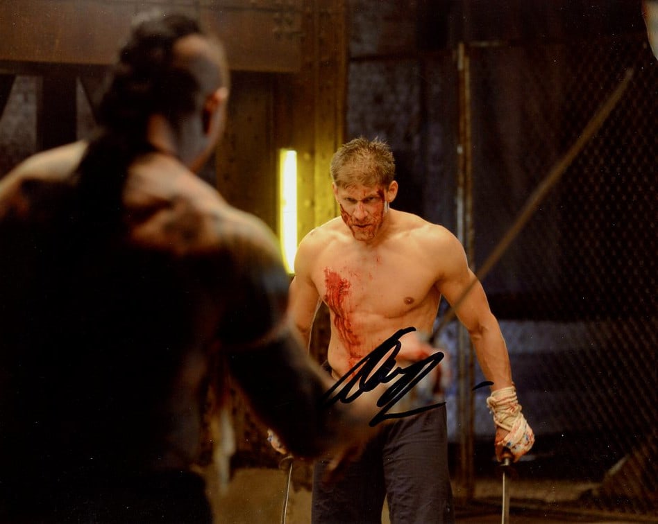 Alain Moussi KICKBOXER VENGEANCE In Person Signed Photo: Photo size is 8x10. Alain Moussi in person signed autographed photo from the movie KICKBOXER: VENGEANCE. Alain Moussi as the character Kurt Sloane.