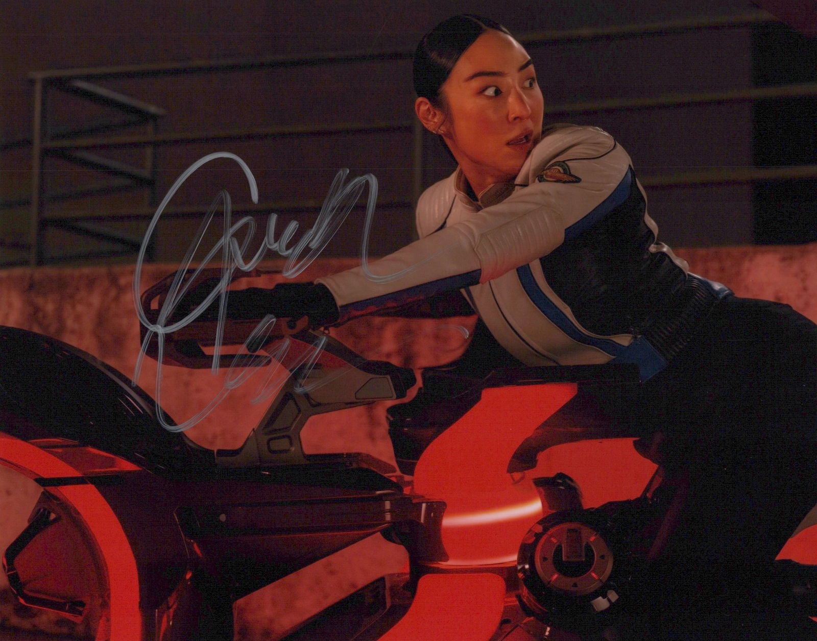 Greta Lee TRON: ARES In Person Signed Photo: Photo size is 8x10. Greta Lee in person signed photo from the movie TRON: ARES. Greta Lee as the character Eve Kim