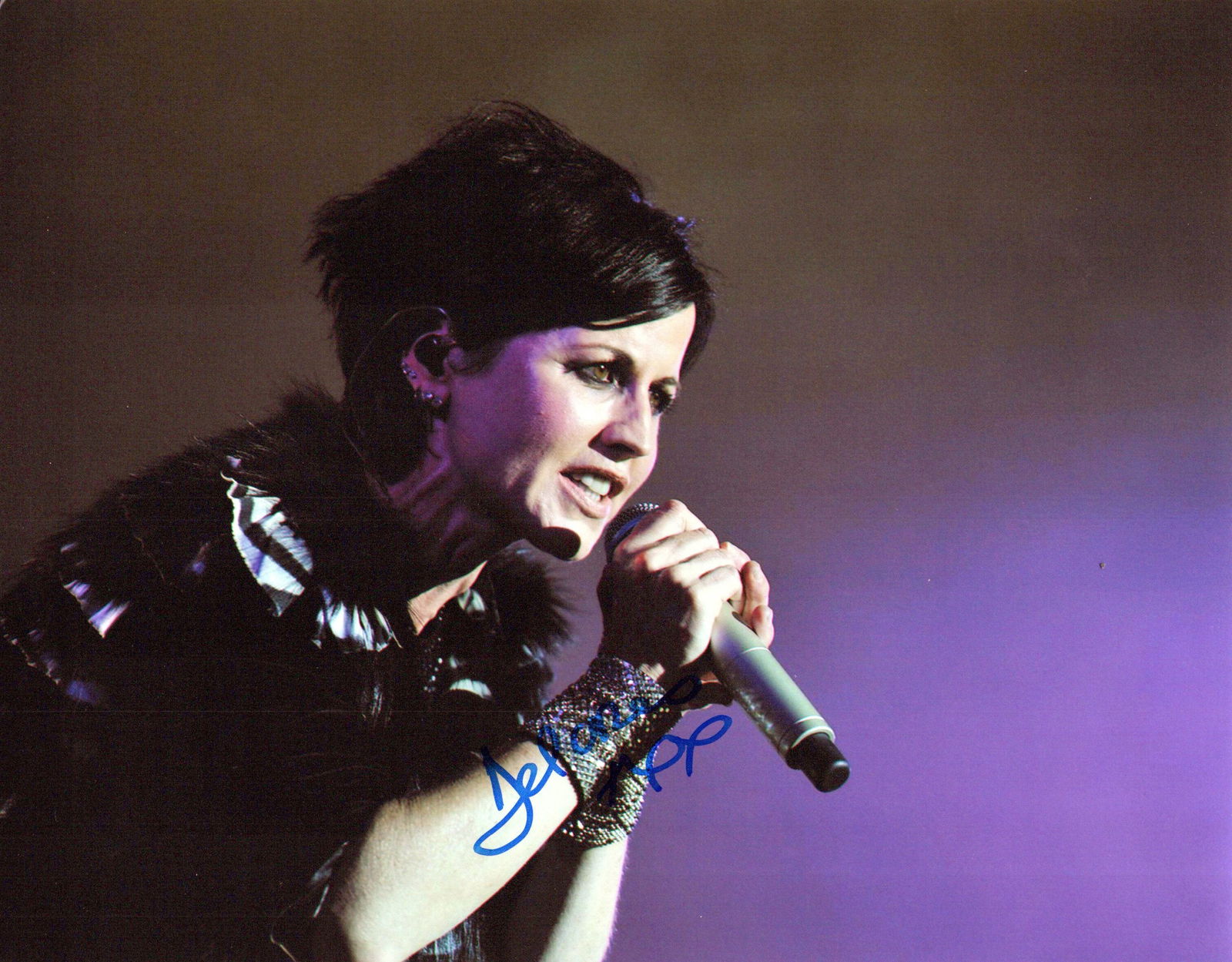 Dolores O'Riordan (1971-2018) THE CRANBERRIES In Person Signed Photo: Photo size is 8x10. Dolores O'Riordan (1971-2018) in person signed photo. Dolores O'Riordan was an Irish musician and singer-songwriter who achieved international fame as the lead vocalist of the rock