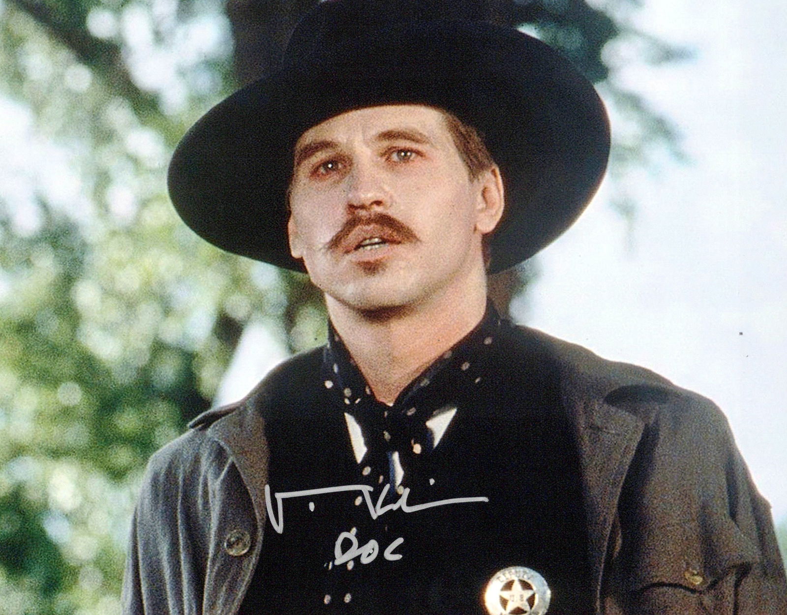 Val Kilmer (1959-2025) TOMBSTONE In Person Signed Photo: Photo size is 8x10. Val Kilmer (1959-2025) in person signed photo from the movie TOMBSTONE. Val Kilmer as the character Doc Holliday.