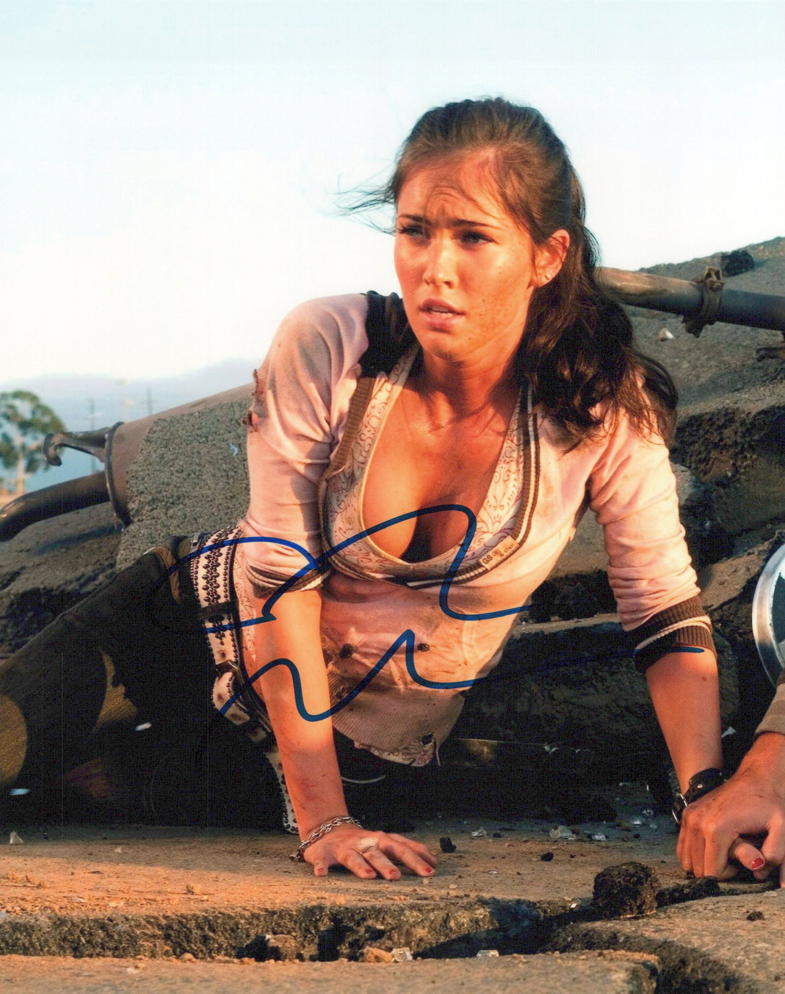 Megan Fox TRANSFORMERS In Person Signed Photo: Photo size is 8x10. Megan Fox in person signed photo from the movie TRANSFORMERS. Megan Fox as the character Mikaela Banes.
