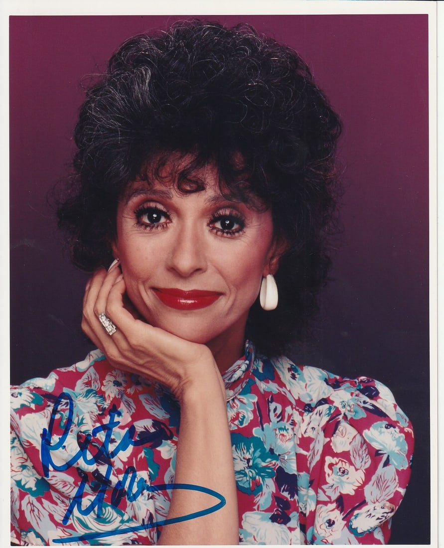 Rita Moreno WEST SIDE STORY / OZ In Person Signed Photo: Photo size is 8x10. Rita Moreno in person signed photo. Rita Moreno has done such TV and movies as WEST SIDE STORY, OZ, and THE KING AND I.