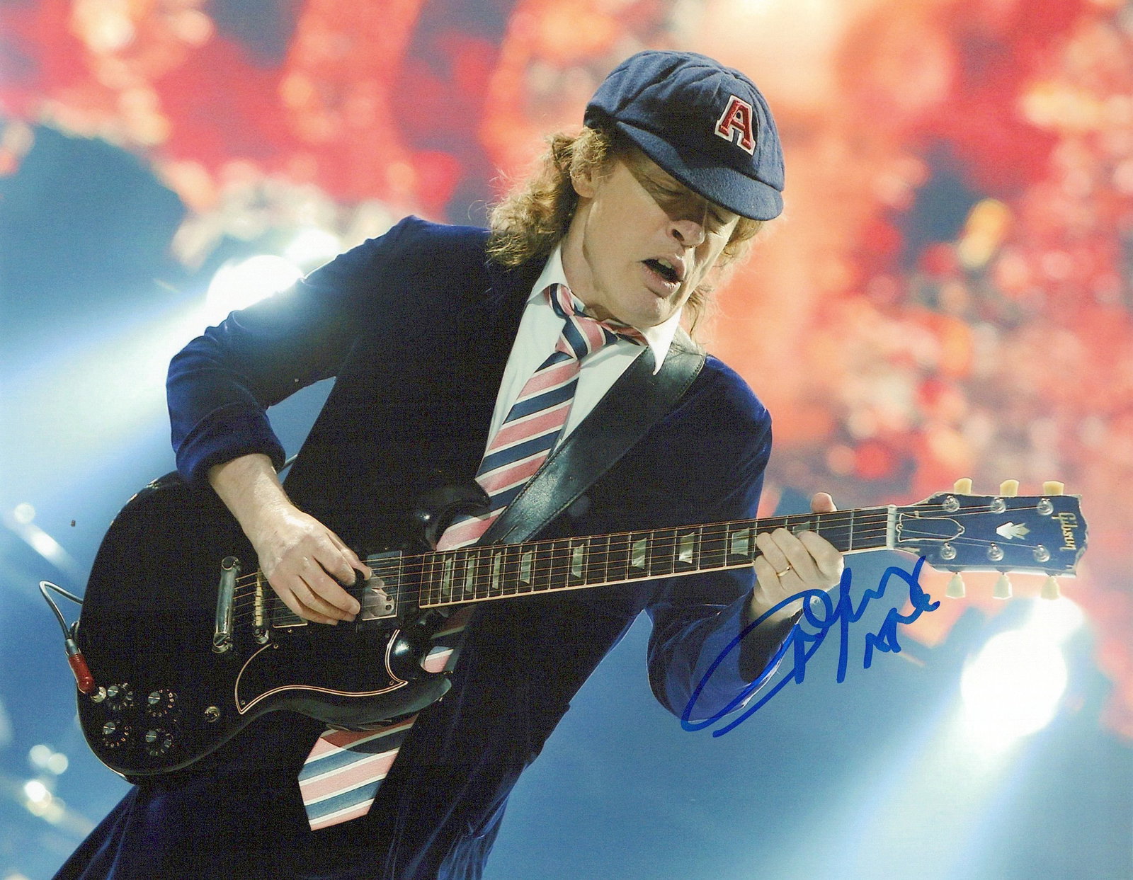 Angus Young AC/DC In Person Signed Photo: Photo size is 8x10. Angus Young in person signed photo. Angus McKinnon Young is an Australian musician, songwriter, and the lead guitarist for the hard rock band AC/DC. Born in 1955, he's the band's
