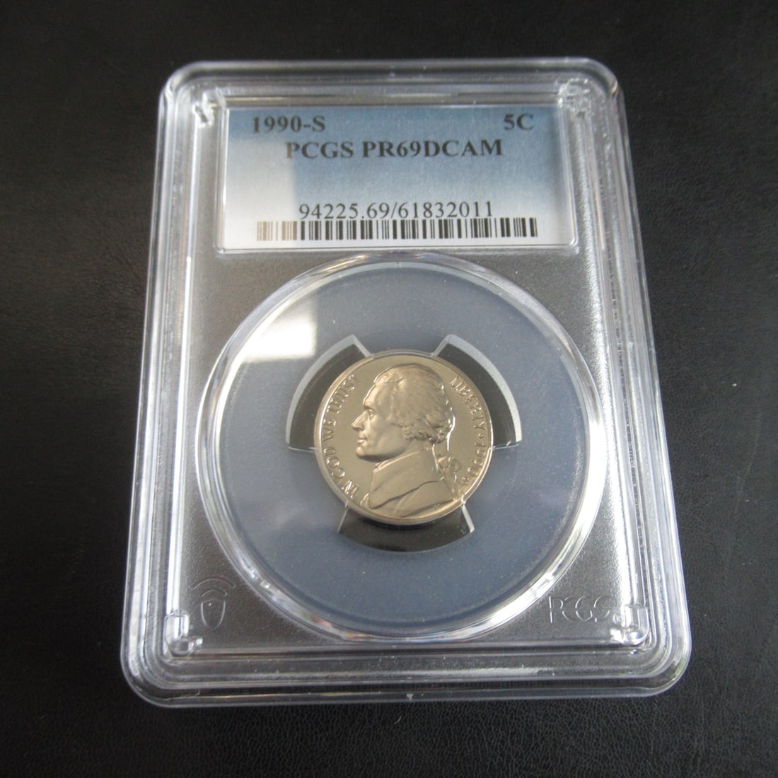 1990-S Jefferson Nickle - Graded PR69DCAM: This item is a 1990-S Jefferson nickel a five cent United States coin struck at the San Francisco mint. It is a proof coin, specifically designed for collectives with high quality detail in the mirror
