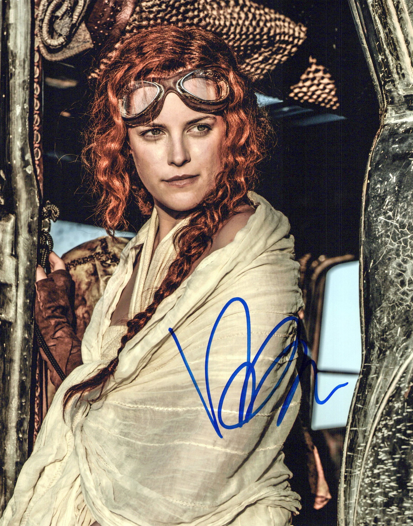 Riley Keough MAD MAX In Person Signed Photo: Photo size is 8x10. Riley Keough in person signed photo from the movie MAD MAX FURY. Riley Keough as the character Capable.